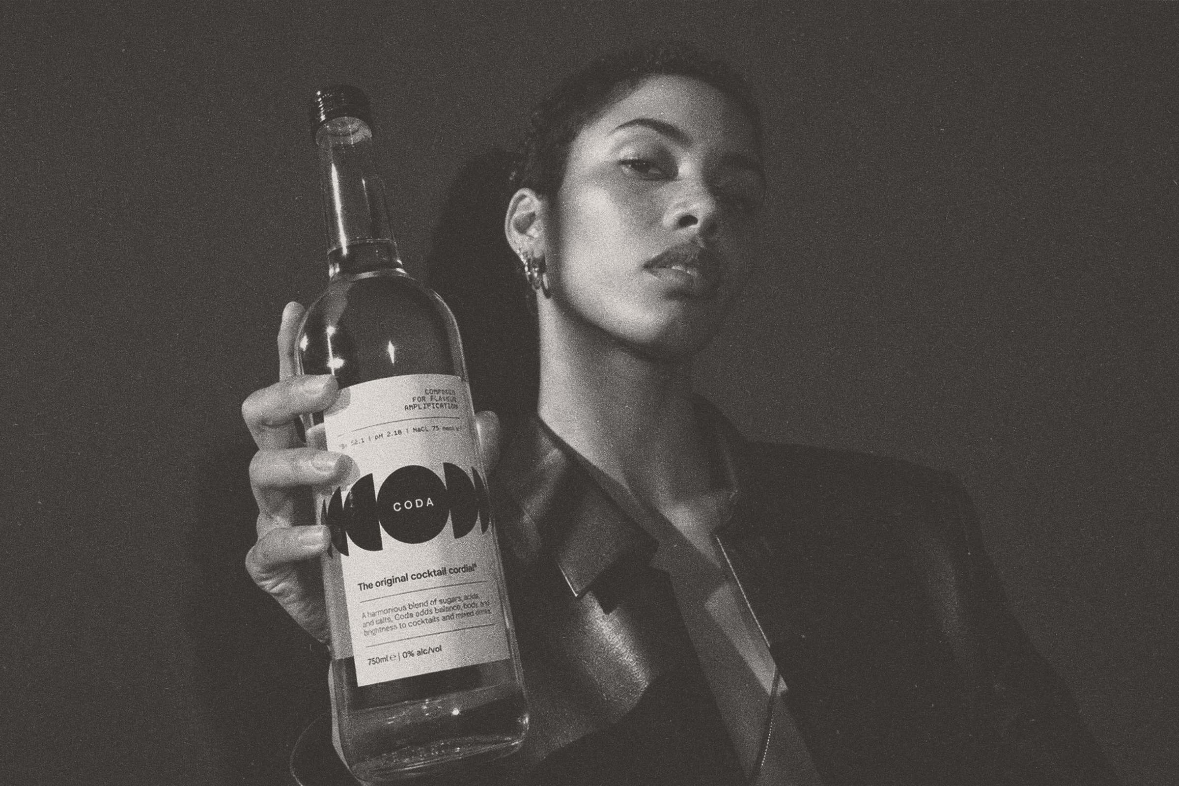 A hand holds the Coda bottle beside a face in profile